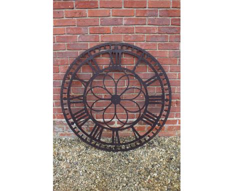 A CIRCULAR PIERCED STEEL CLOCK FACE with roman numerals, 112cm diameter 