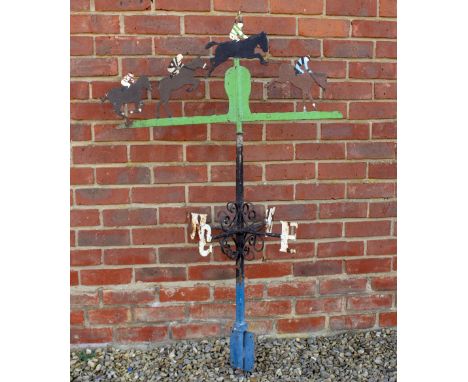 AN EARLY 20TH CENTURY PAINTED WROUGHT IRON WEATHER VANE in the form of a horse race, with the four points of the compass indi
