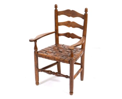 A MID 20TH CENTURY GORDON RUSSELL YEW WOOD CHILD'S LADDER BACK ARMCHAIR with acorn finials, scrolling arms, leather strap wor