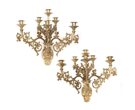 A PAIR OF GILT BRASS GOTHIC REVIVAL FIVE BRANCH SIX LIGHT WALL SCONCES with stylised leaf decoration, approximately 44cm high