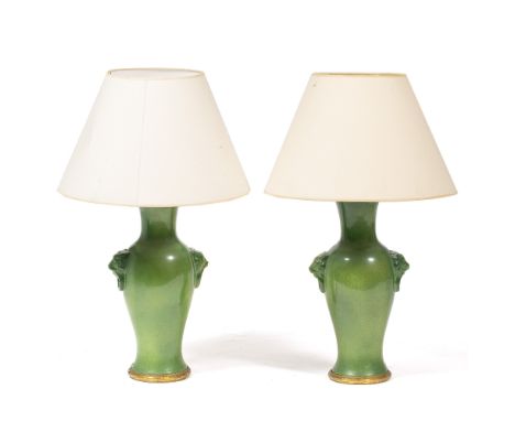 A PAIR OF MID 20TH CENTURY GREEN GLAZED TABLE LAMPS  in the form of baluster urns with lion mask ring decoration and with orm