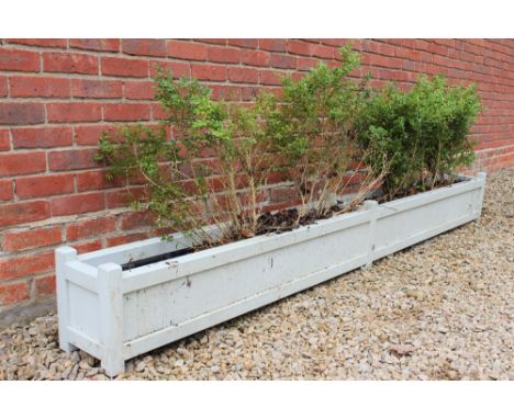 A PAINTED WOOD EFFECT GARDEN PLANTER of long rectangular form, 263cm long x 24.5cm deep x 30cm high