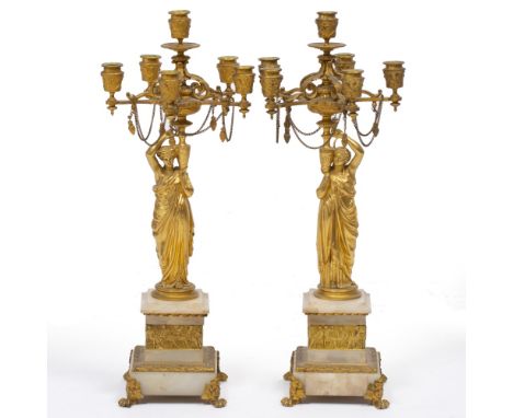 A PAIR OF 19TH CENTURY FRENCH ORMOLU SIX LIGHT CANDELABRA the five radiating branches with scroll brackets, supported by Clas