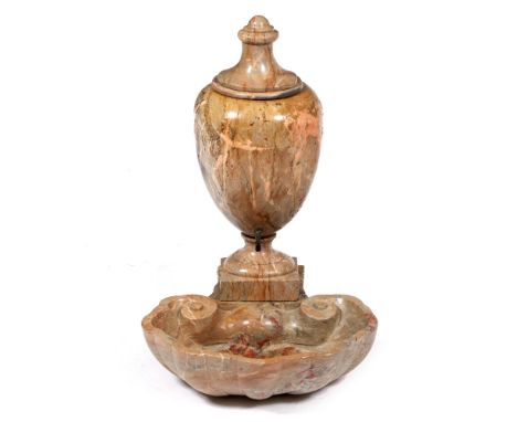 A MARBLE WALL MOUNTED SHELL SHAPED WASH BASIN with lidded vase water cistern above, 43.5cm wide x 50cm deep x 64cm high overa