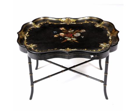 A VICTORIAN PAPIER MACHE TRAY  of shaped serpentine outline, centrally decorated with inset mother of pearl and sprays of flo