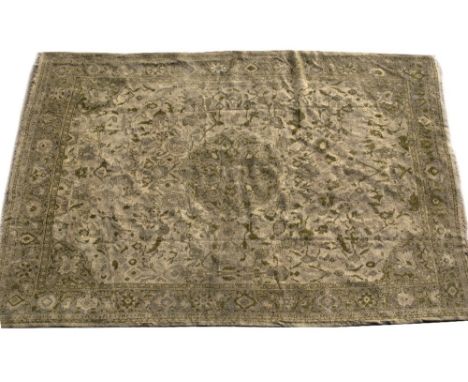 AN OLD INDIAN LIGHT GREEN GROUND SMALL CARPET with central stylised motif surrounded by flowers to the field and within a ban