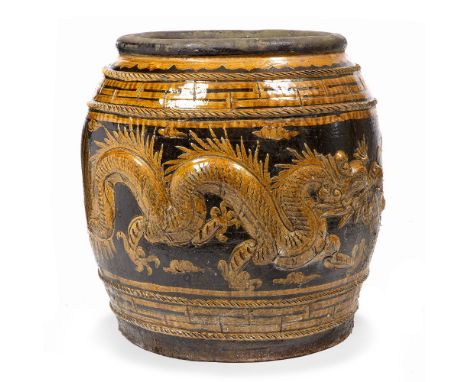 A LARGE OVOID STONEWARE PLANTER with honey glaze and moulded with writhing dragons 62cm diameter x 66cm high 