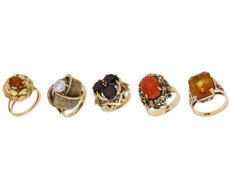 A collection of mid 20th century gem-set rings, the stylised dress rings vari-set with citrine, garnet, Corallium Rubrum and 