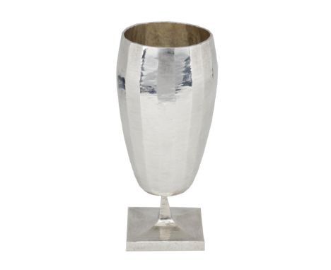 A Britannia silver red wine goblet, by Louis Osman, 1974, of faceted gently ovoid form, on square pedestal foot, with hammere