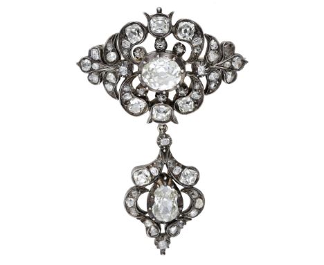 An early 19th century diamond brooch, set with an oval-cut diamond within a pierced lozenge-shaped surround with scroll and f