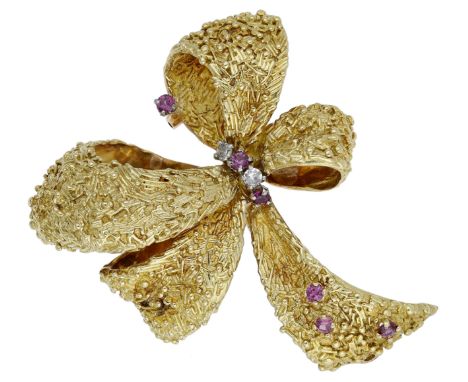 A mid 20th century gem-set brooch, the highly sculptural bow with textured finish and single-cut diamond and circular-cut rub