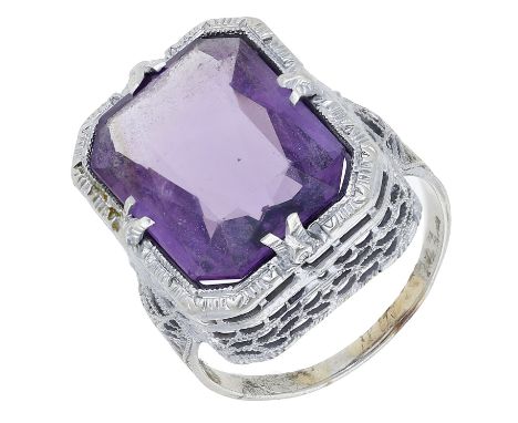 An amethyst dress ring, probably American, the cut-cornered amethyst set to a pierced mount with millegrain decoration throug