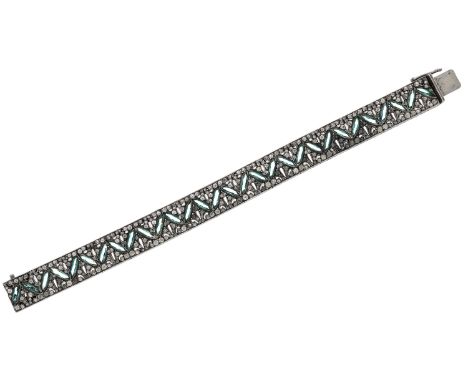 An early 20th century paste bracelet, the articulated pierced panels set throughout with vari-cut white and green paste stone