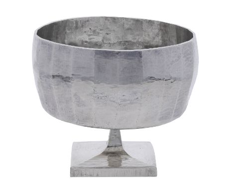 A Britannia silver champagne goblet by Louis Osman, 1974, of faceted squat gently ovoid form on a square pedestal foot, with 