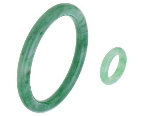 A jadeite bangle and ring, polished and with mottled green and white colouring, bangle inner dimensions approximately 6 x 5cm