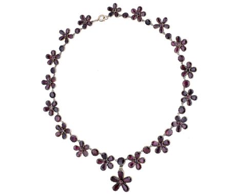 A floral garnet necklace, circa 1820, the necklace composed of garnet flowerhead clusters spaced by circular-cut stones and s