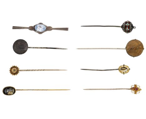 A collection of antique stick pins, set with various gemstones to include a hardstone seal with carved masonic square and com