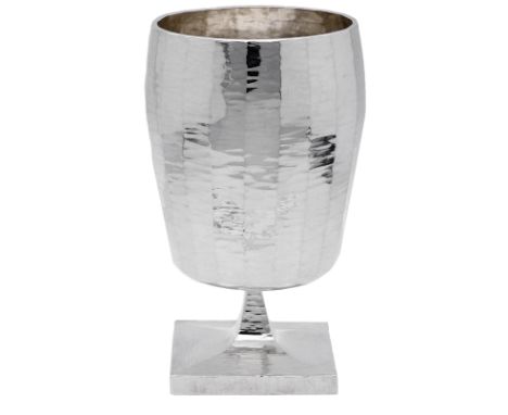 A Britannia silver white wine goblet, by Louis Osman, 1969, of faceted gently ovoid form, with hammered finish, hallmarked fo