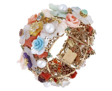 A vari gem-set bracelet, possibly by Giampiero Fiorini, the highly decorative bangle with pierced frame and mounted throughou