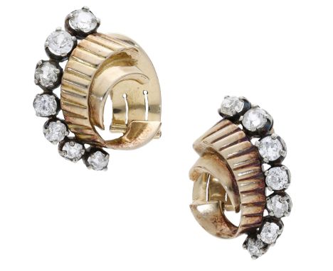A pair of diamond set ear clips, circa 1940, each scroll with reeded decoration and set with a graduated row of old brilliant