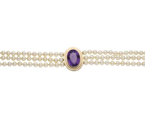 A three row cultured pearl necklace, centred with an oval-cut amethyst, within a stepped collet mount, length approximately 4