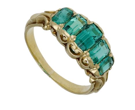 A late 19th century emerald five stone ring, the graduating row of step-cut emeralds to a pierced scroll gallery, mounted in 