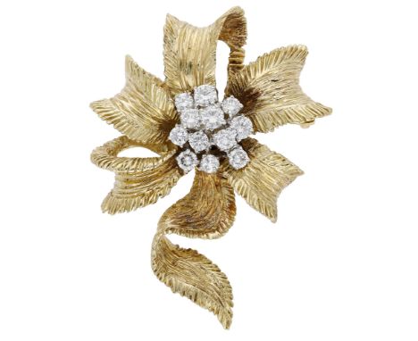A diamond set ribbon brooch by Kutchinsky, the sculptural ribbon with fluted bands and textured finish, centred with a brilli
