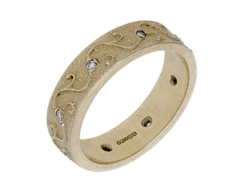 A diamond ring by Ola Gorie, the textured 9ct gold band with scrolling wirework of foliate design and set with brilliant-cut 