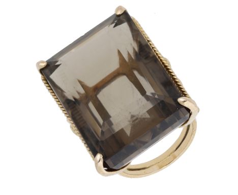 A smoky quartz dress ring, the large step-cut smoky quartz claw-set between a ropetwist mount with flowerhead motif decoratio