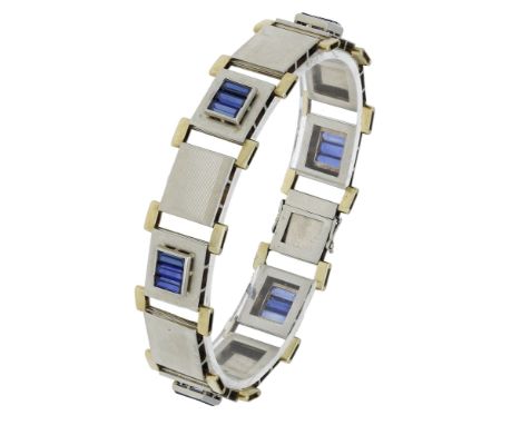 A bicoloured bracelet, designed as a series of rectangular plaques, alternately decorated with linear engraving and step-cut 