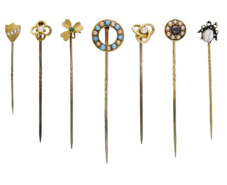 A collection of antique stickpins, comprising a turquoise and seed pearl hoop example, a quatrefoil and pearl example, a diam