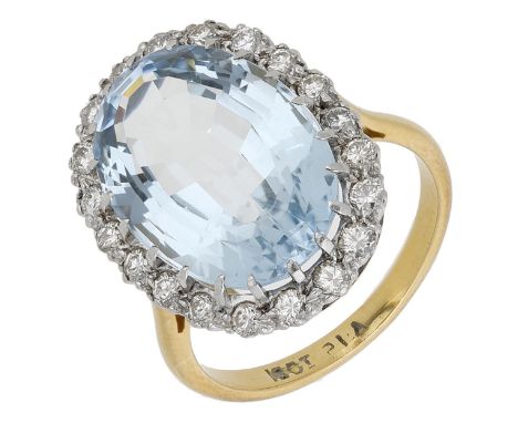 An aquamarine and diamond cluster ring, the oval-cut aquamarine within a surround of brilliant-cut diamonds, stamped ‘18CT & 