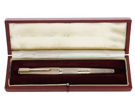 A 9ct gold fountain pen by Parker, engine-turned and with hooded nib, cartridge reservoir, engraved with initials ‘G P R’ and