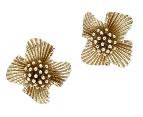 A pair of flowerhead ear clips, with polished stamen and undulating reeded petals, stamped ‘14K’, length 25mm.  £400-£500  --