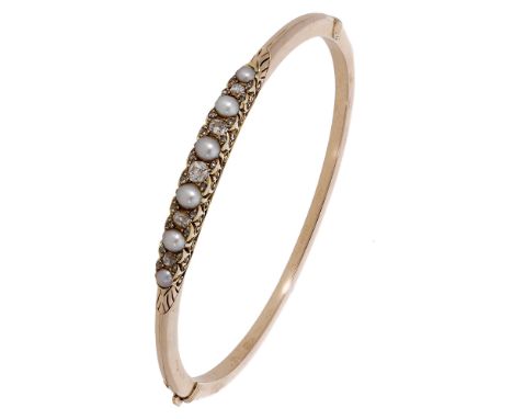 A late 19th century pearl and diamond bangle, the front set with alternating half-pearls and old brilliant-cut diamonds, with