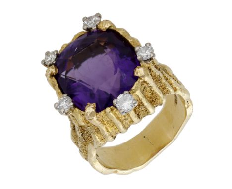 An 18ct gold amethyst and diamond dress ring by Alan Martin Gard, 1968, the oval mixed-cut amethyst edged by outset of brilli