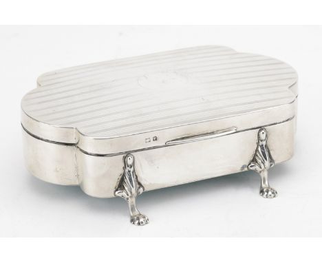 A George V silver jewellery box, of rectangular form with bowed ends, the lid engine-turned, on outset paw feet, the satin-li