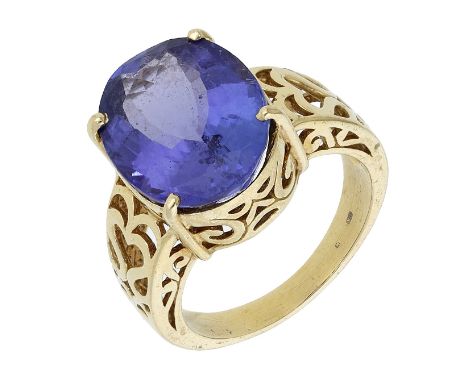 A tanzanite ring, the oval-cut tanzanite in an openwork mount with pierced scroll and heart-shaped decoration, mounted in gol