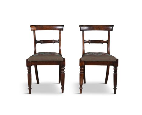 A PAIR OF WILLIAM IV ROSEWOOD DINING CHAIRS,each with curved rail backs and mid rail, fitted with floral tapestry seats, on f