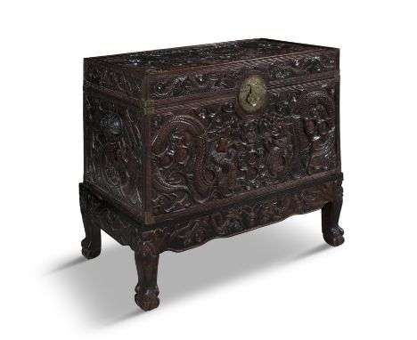 A CHINESE HARDWOOD AND CAMPHORWOOD BLANKET CHEST, C.1900the exterior carved to all sides with dragons, flaming pearls and clo