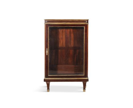 A FRENCH MAHOGANY AND PARCEL GILT SIDE CABINET,above a glazed panel door, shelved interior, on squared tapering legs. 74cm wi