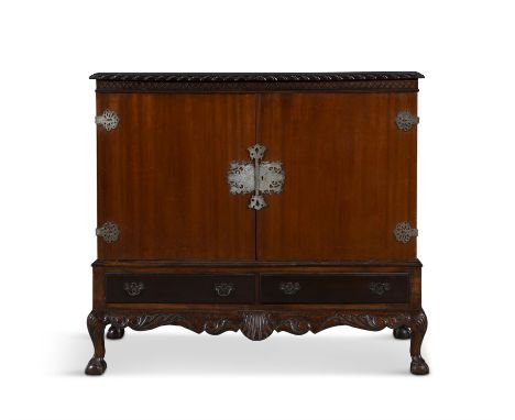 A MAHOGANY CHIPPENDALE STYLE TWO DOOR SIDE CABINETwith gadrooned edge,  brass mounts and a shelved interior , on a two drawer