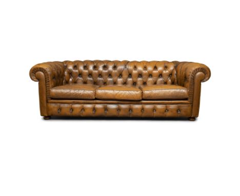  A CHESTERFIELD BUTTON BACK THREE SEATER SOFA. 210CM WIDE, 66CM HIGHupholstered in brown leather, with scroll-end arms, loose