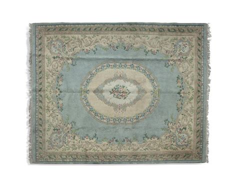 A LARGE INDIAN WOOL CARPET, 368 x 460cmthe pale blue ground with central oval medallion in off white, within a foliate border