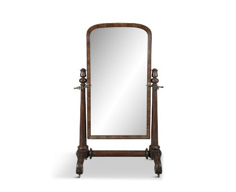A VICTORIAN MAHOGANY FRAMED CHEVAL MIRROR,the domed framed mirror on tapestry column side supports, with attached hinged cand