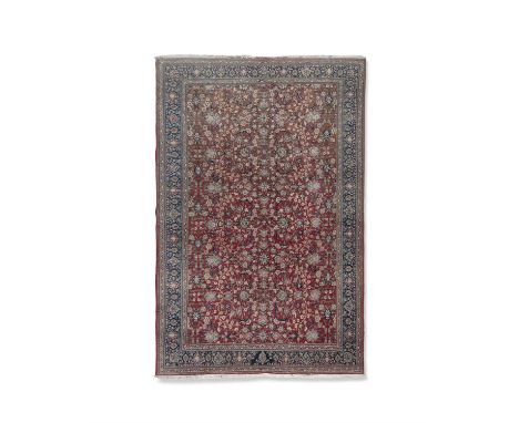 A PERSIAN WOOL CARPET 346 X 269CMthe closely decorated reserve within blue guard stripes to border.