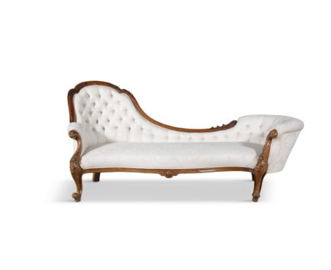 A VICTORIAN WALNUT FRAMED CHAISE LONGUE with button back cream damask upholstery, on carved scroll legs. 87.5cm high (highest