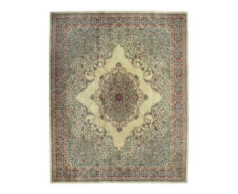 A LARGE WILTON WOOL FLOOR CARPET. 453 X 366CMof Axminister design, in soft green, navy and coloured tones, centred with large
