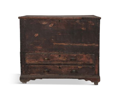 A PROVINCIAL STAINED PINE BLANKET CHEST,c.1800, the rectangular lift top above two long drawers with brass button handles, on