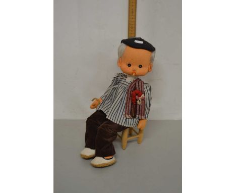 A vintage doll and accompanying chair